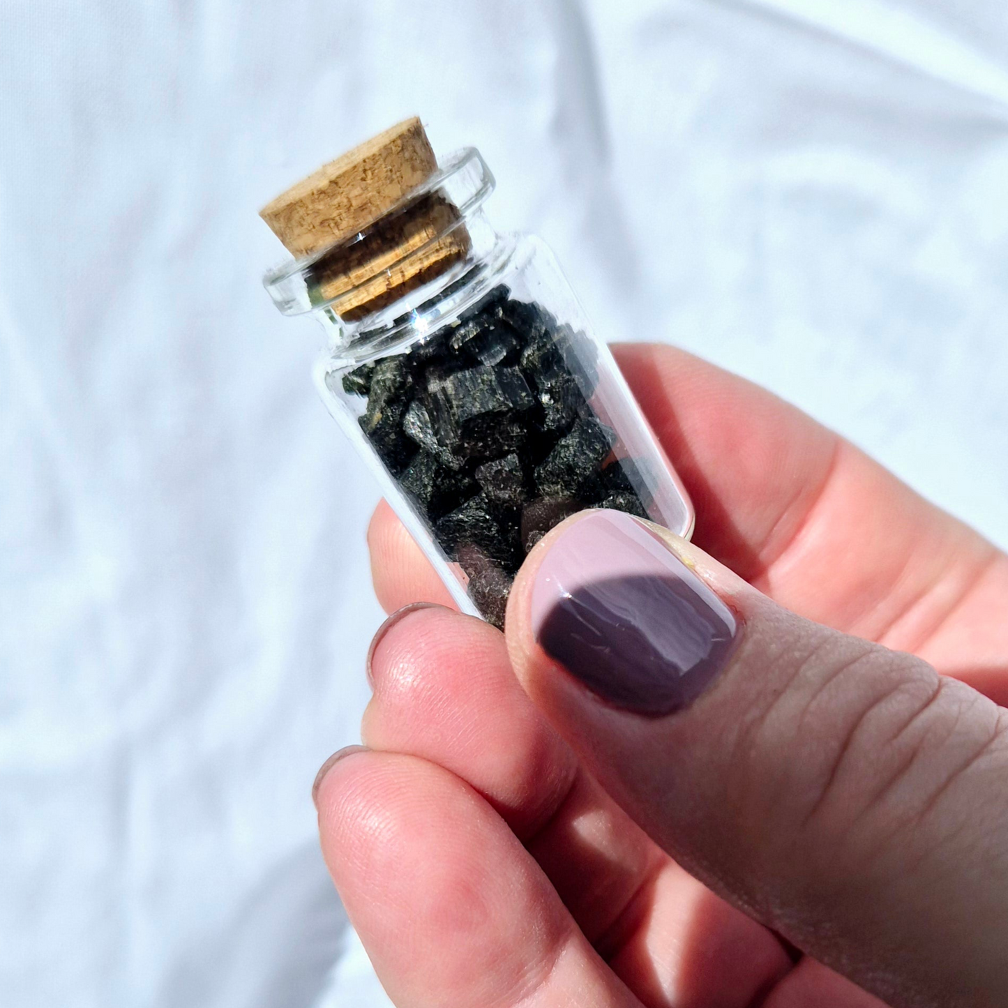 Glass jar filled with black tourmaline chips