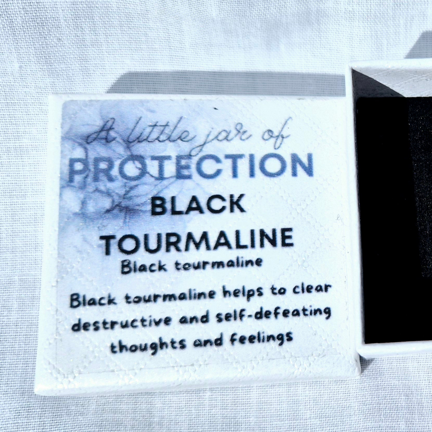 Glass jar filled with black tourmaline chips