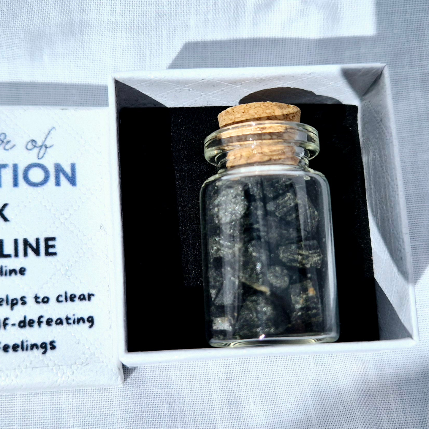 Glass jar filled with black tourmaline chips
