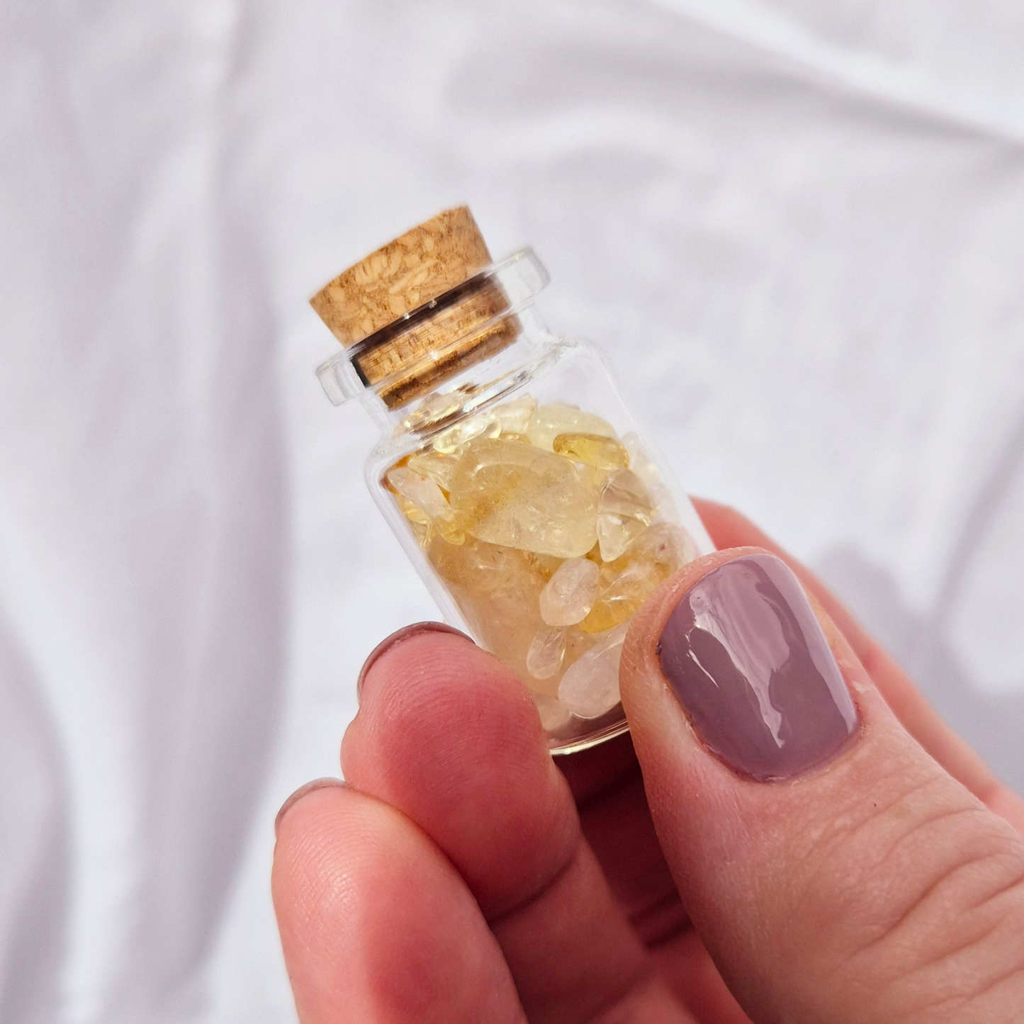 Glass jar filled with vibrant citrine chips
