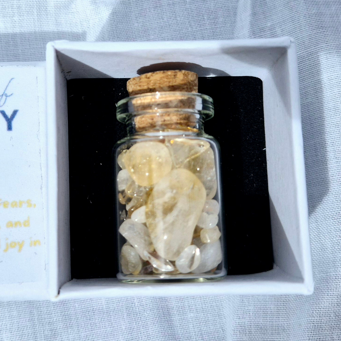 Glass jar filled with vibrant citrine chips