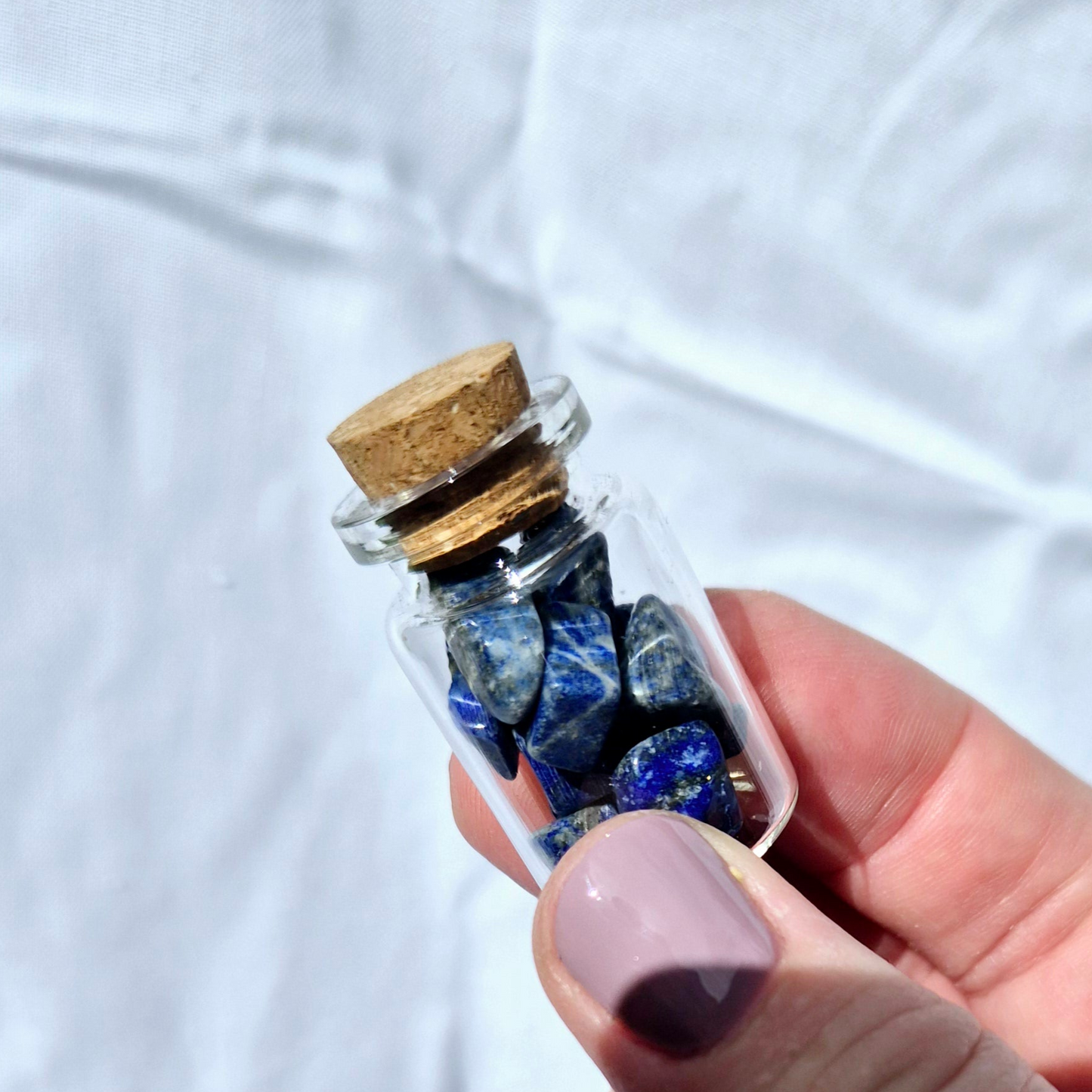 Glass jar filled with vibrant Lapis Lazuli chips