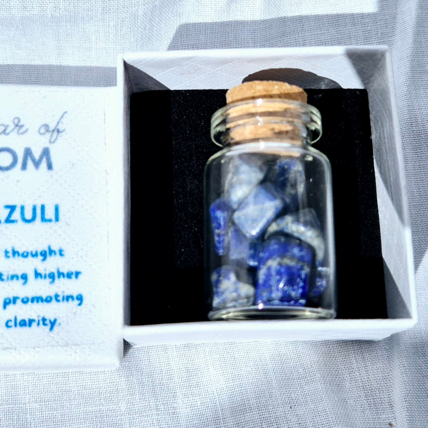 Glass jar filled with vibrant Lapis Lazuli chips