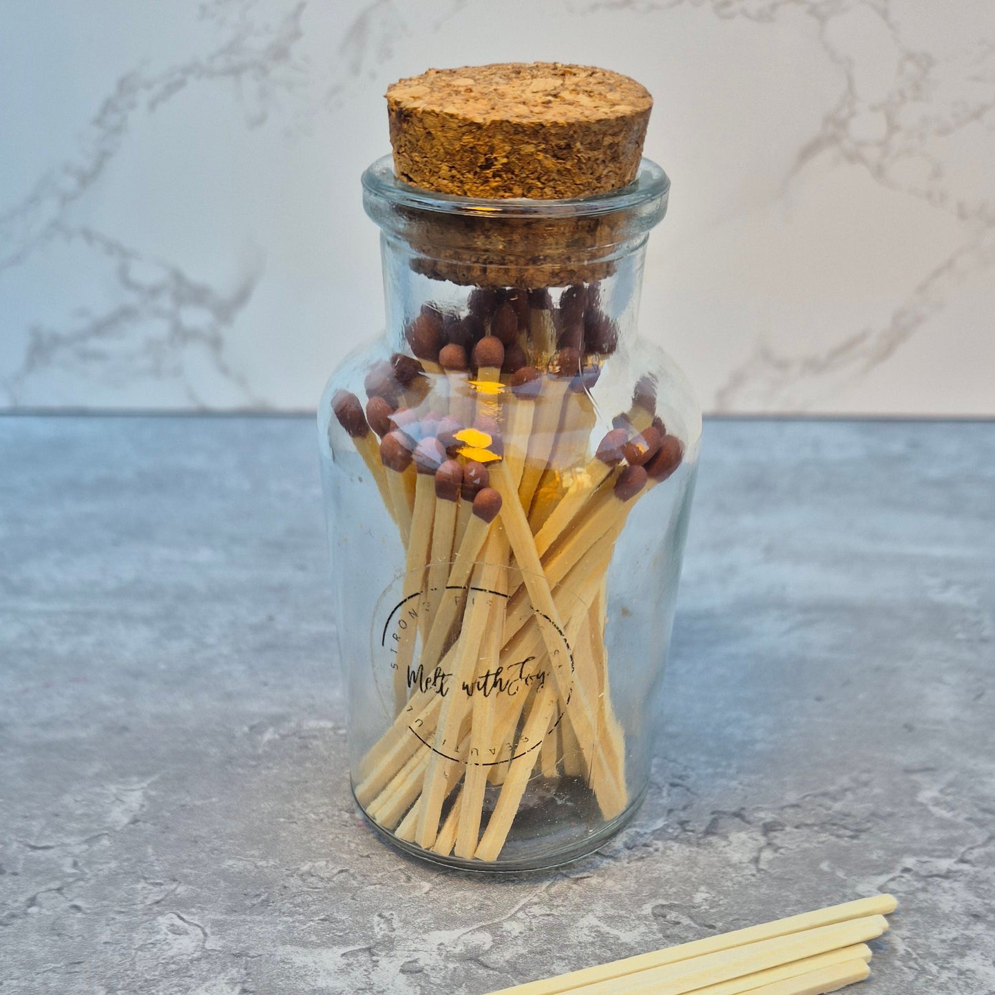 Matches in a glass jar with cork lid