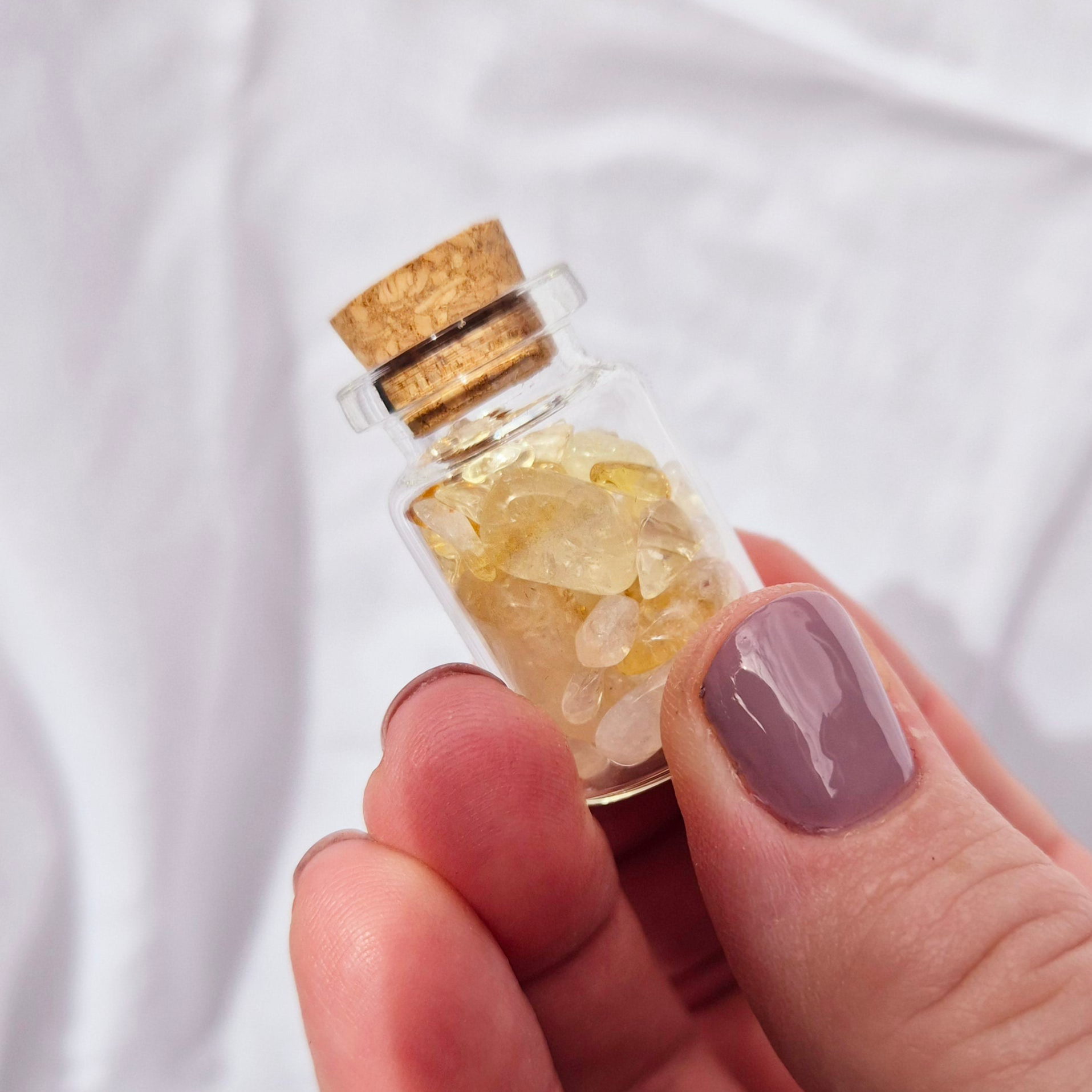 Glass jar filled with vibrant citrine chips