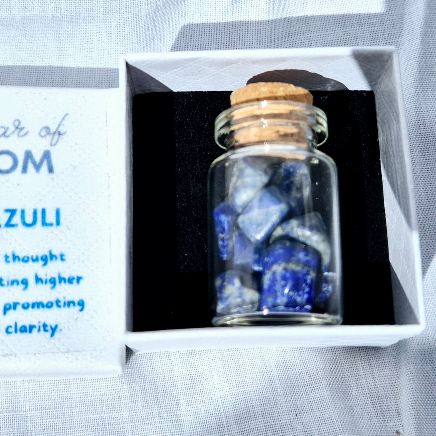 Glass jar filled with vibrant Lapis Lazuli chips