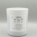 White candle with a label featuring the Virgo zodiac sign on a gray background