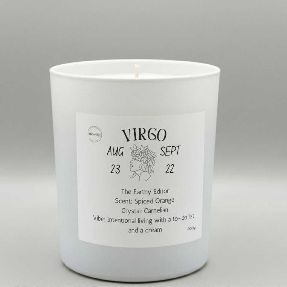 White candle with a label featuring the Virgo zodiac sign on a gray background