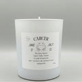 White candle with a label indicating 'Cancer' on a gray background