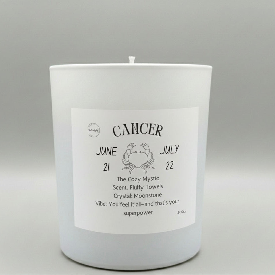 White candle with a label indicating 'Cancer' on a gray background