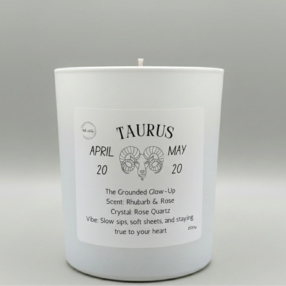 Candle with Taurus zodiac design on a gray background