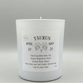 Candle with Taurus zodiac design on a gray background