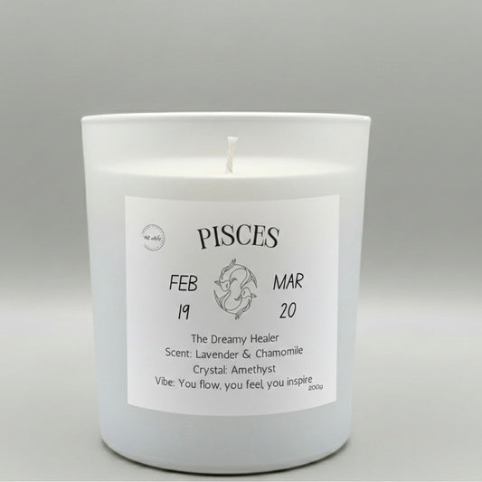 White candle with a label indicating 'Pisces' on a gray background