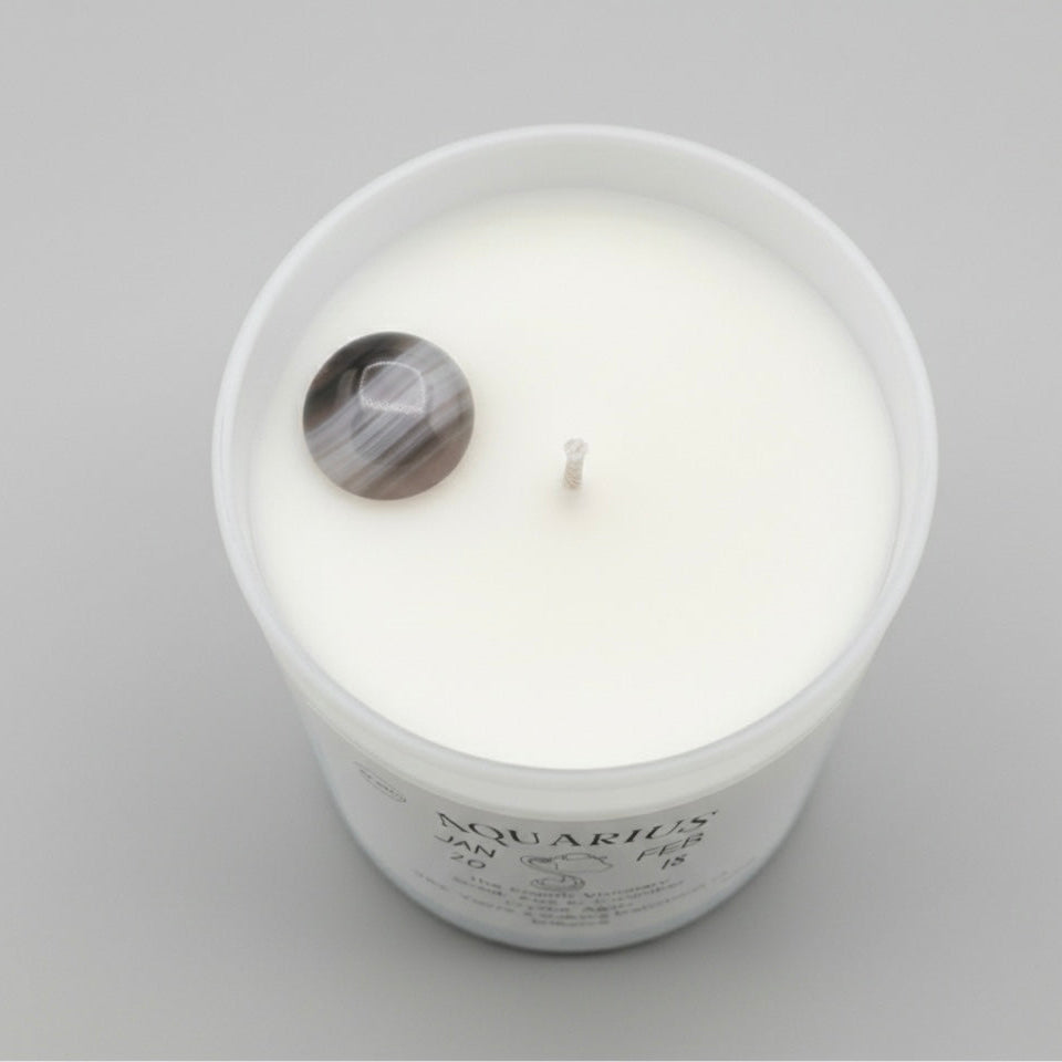 Candle labeled 'Aquarius' on a gray background