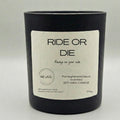 Black candle with a white label on a light gray background