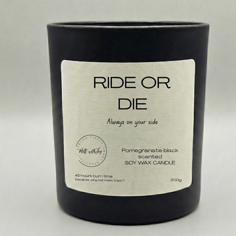 Black candle with a white label on a light gray background