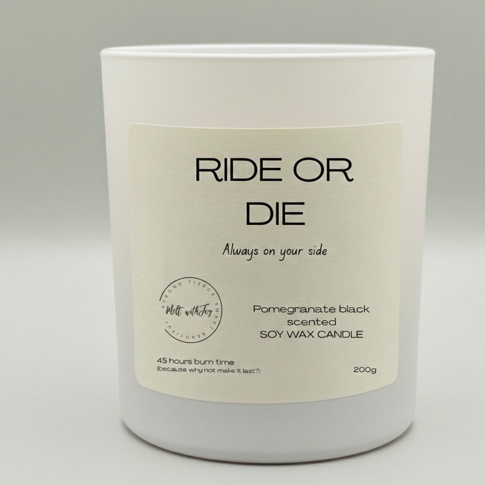 Candle with 'Ride or Die' label on a gray background
