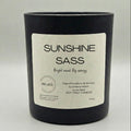 Black candle with a label on a light gray background