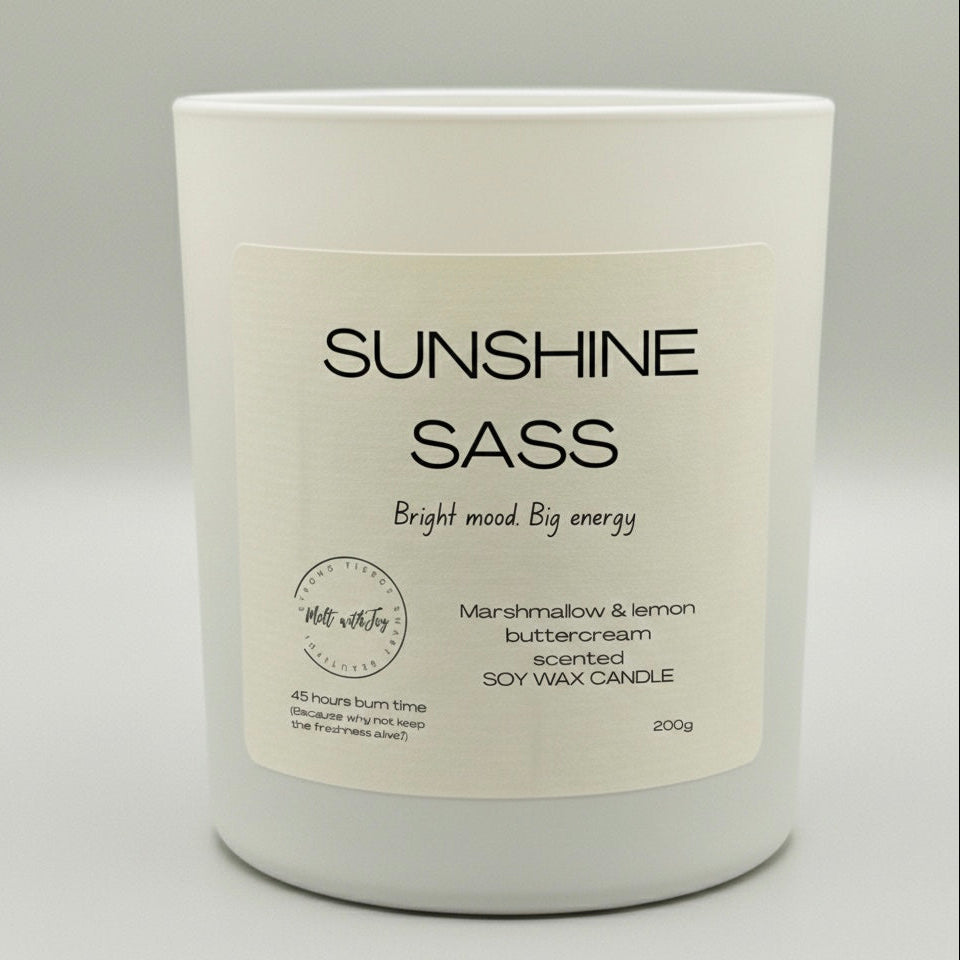 Candle labeled 'Sunshine Sass' with a light gray background