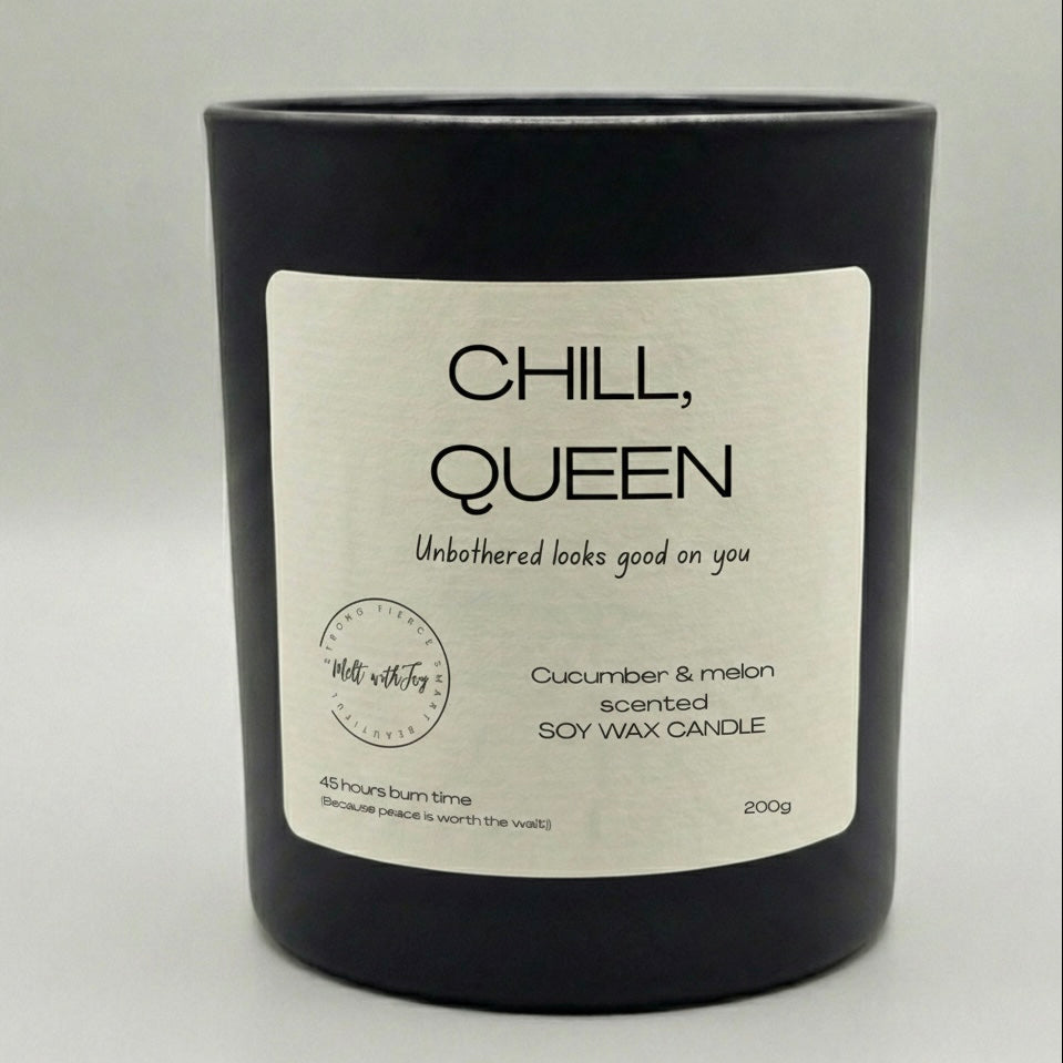 Black candle with a 'Chill, Queen' label on a light gray background