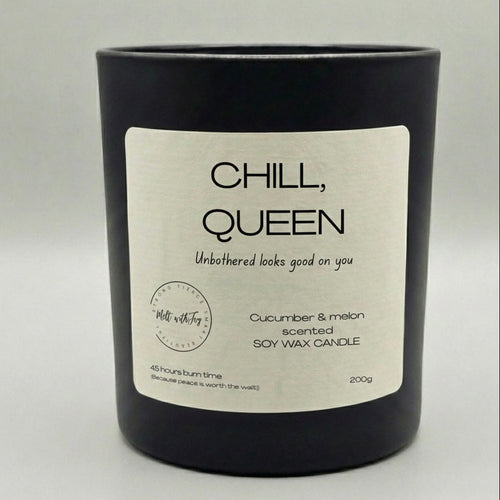 Black candle with a 'Chill, Queen' label on a light gray background