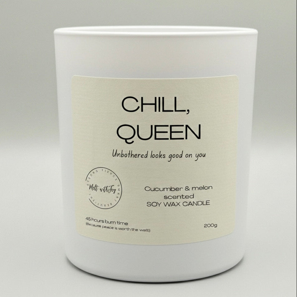 Candle with 'Chill, Queen' label on a gray background
