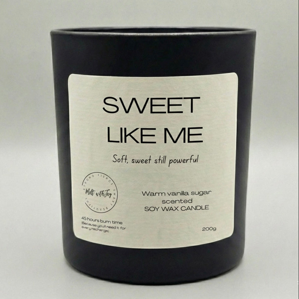 Black candle with a white label on a light gray background