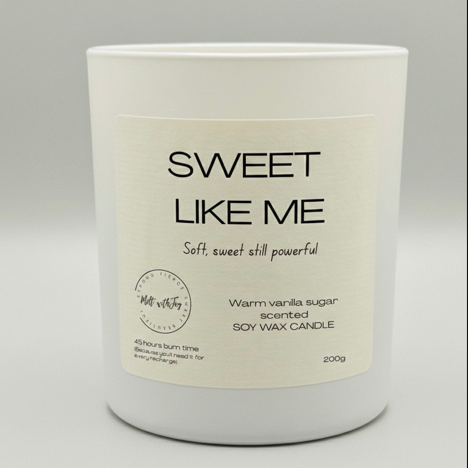 White candle with 'Sweet Like Me' label on a light gray background