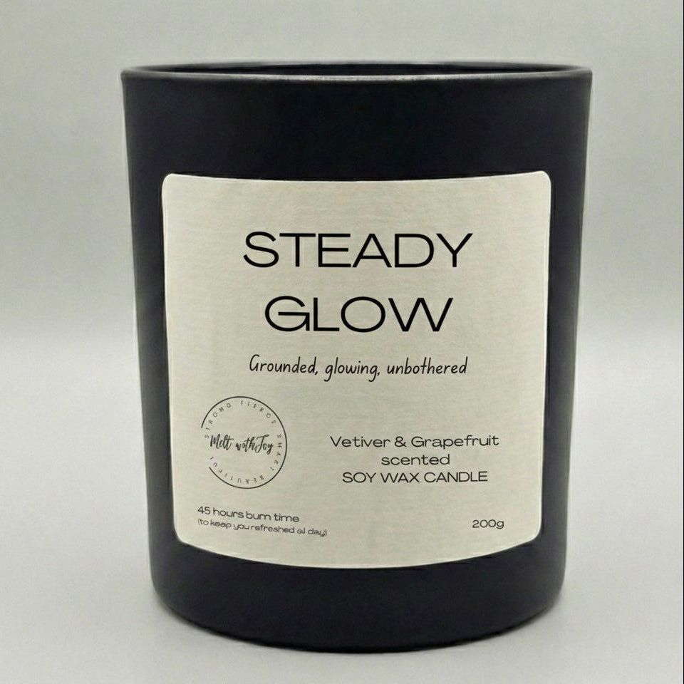 Black candle with a label titled 'Mama Bear Mode' on a light gray background