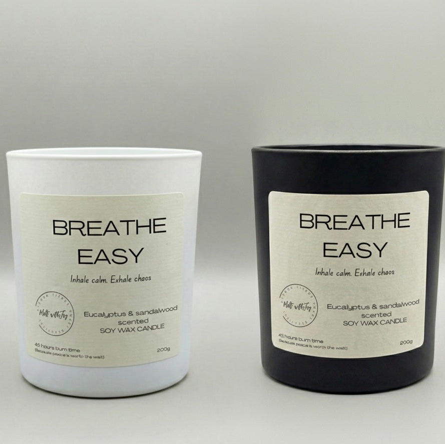 Two candles labeled 'Breathe Easy' on a gray background