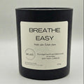 Black candle with a label on a light gray background