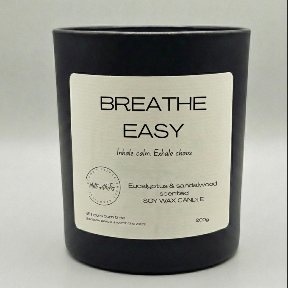 Black candle with a label on a light gray background