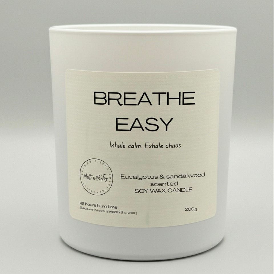 Candle with 'Breathe Easy' label on a gray background