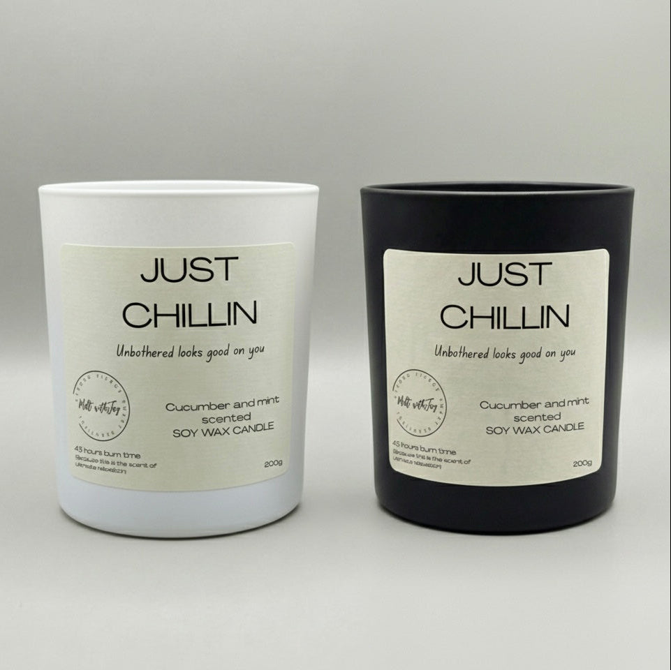 Two candles, one white and one black, with 'Just Chillin' labels on a gray background.