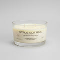 Candle labeled 'Citrus Got Real' on a light gray background