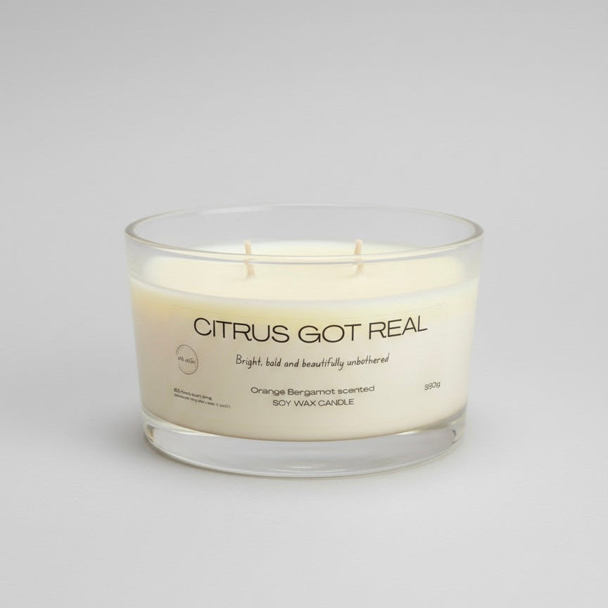 Candle labeled 'Citrus Got Real' on a light gray background