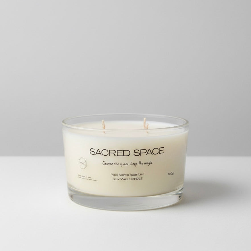 Candle labeled 'Sacred Space' on a white background