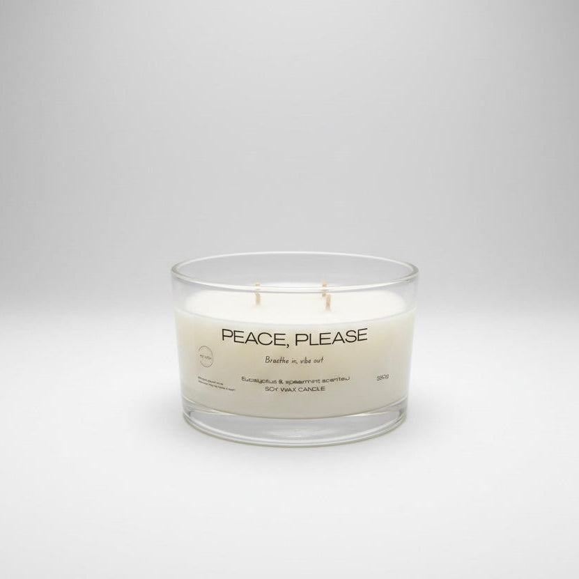 Candle with 'Peace, Please' text on a white background