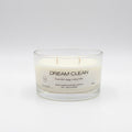 Glass candle with 'Dream Clean' label on a white background