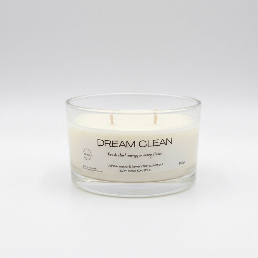 Glass candle with 'Dream Clean' label on a white background