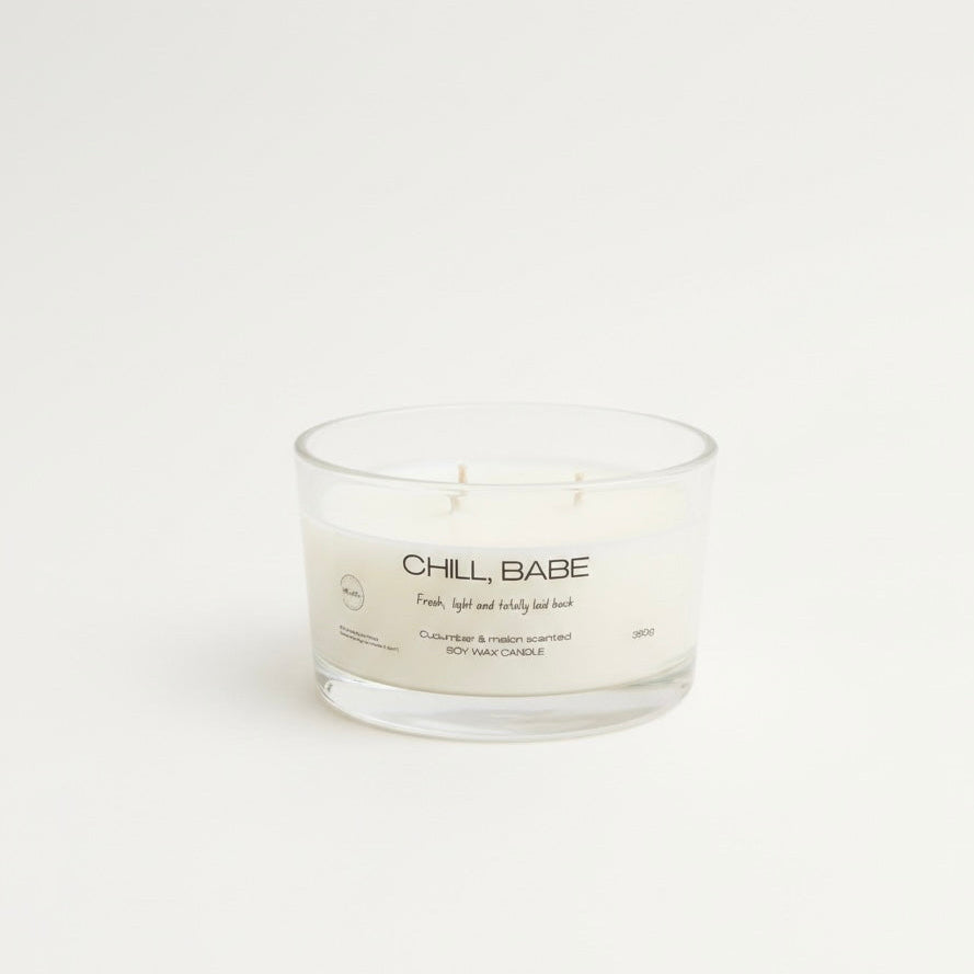 Candle in a glass jar with 'Chill, Babe' text on a white background