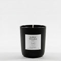 Black candle with a white label on a white background