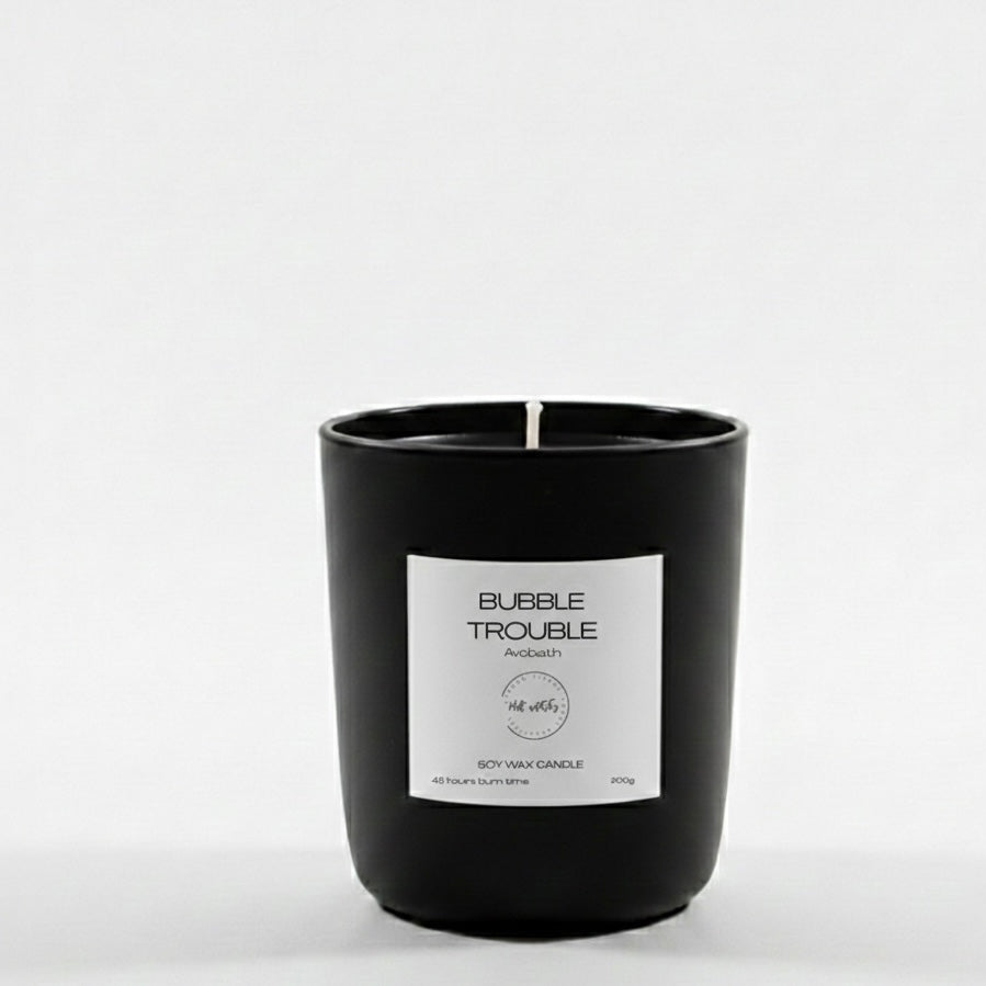 Black candle with a white label on a white background