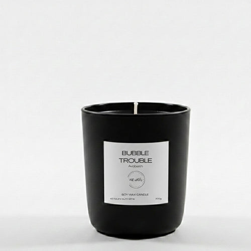 Black candle with a white label on a white background