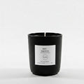 Black candle with a white label on a white background
