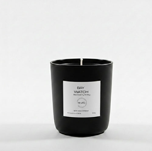 Black candle with a white label on a white background
