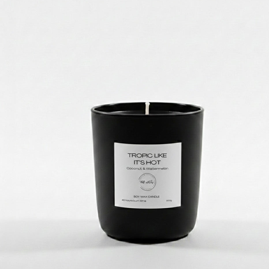 Black candle with a label on a white background