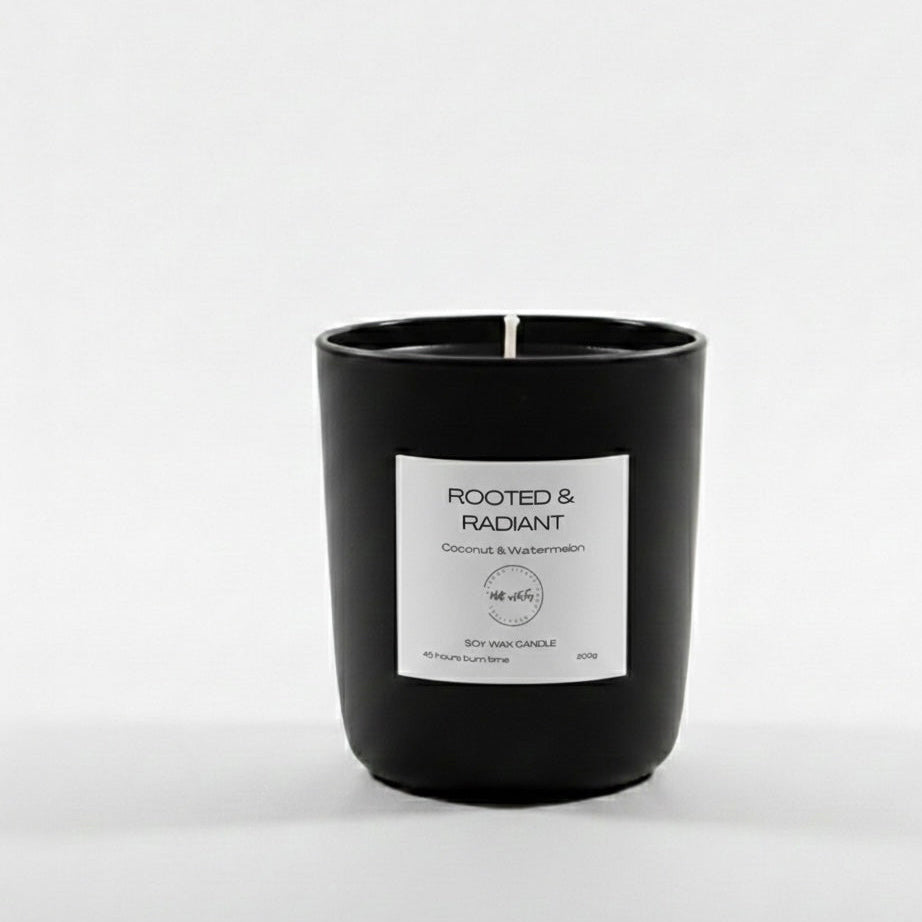 Black candle with a white label on a light gray background
