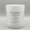 White candle with a label on a gray background