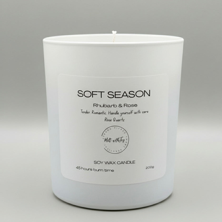 White candle with a label on a gray background
